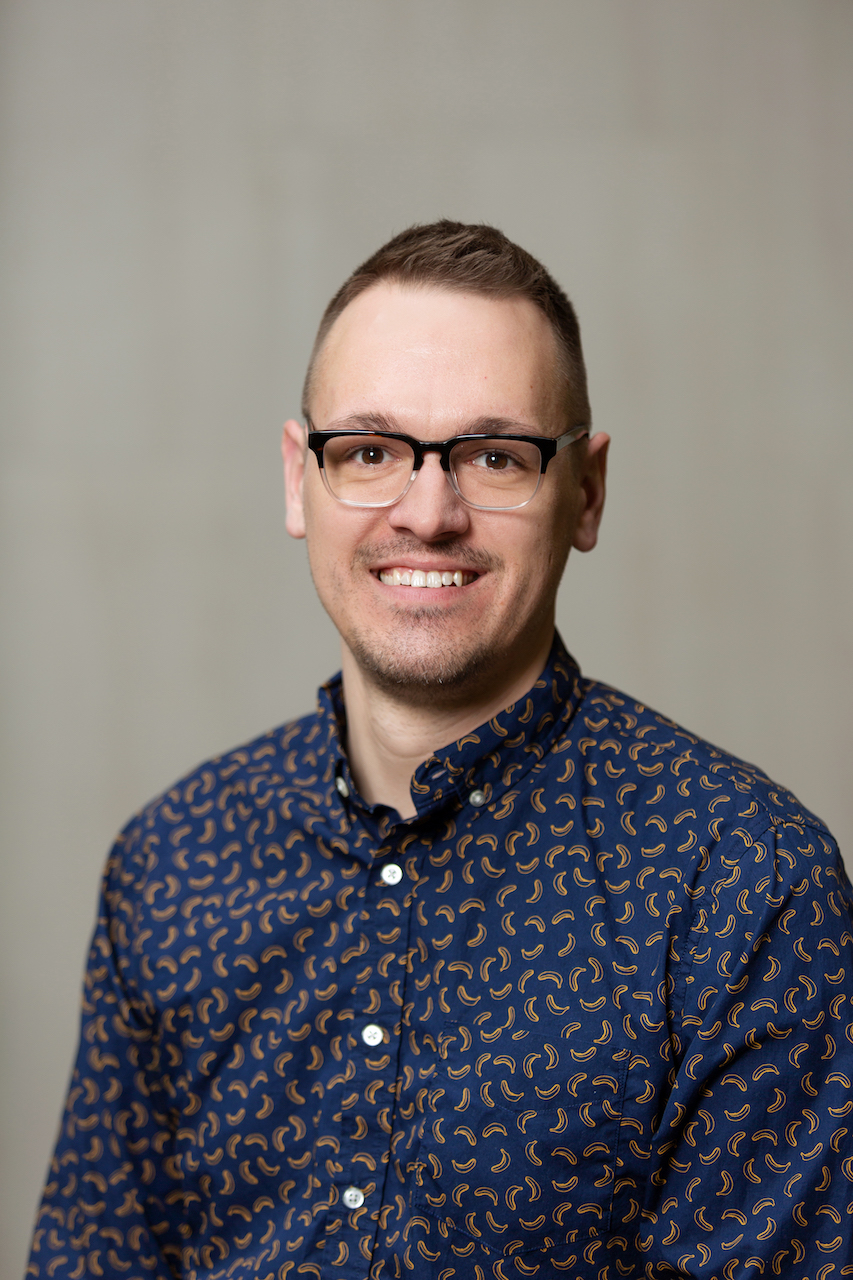 head-shot of Jeremy in a blue shirt and glasses